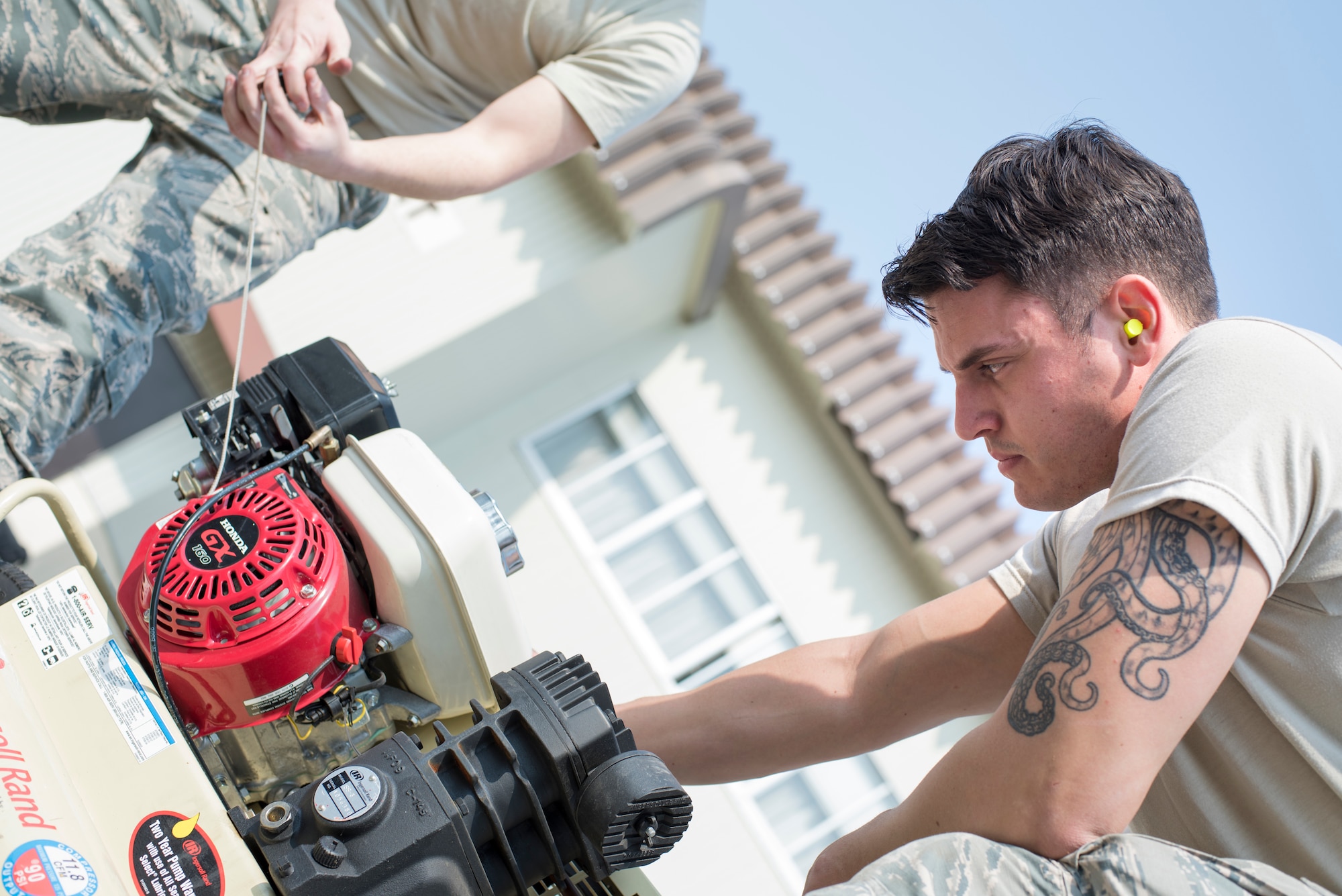 U.S. Air Force Airman 1st Class Kevin Corr, a 35th Logistics Readiness Squadron firetruck refueling technician, inspects a motor during the first LRS Agile Combat Employment exercise at Misawa Air Base, Japan, March 20, 2019. An air compressor allows Airmen to access pressurized air which converts power into energy and can be used to service an inoperable motor vehicle. (U.S. Air Force photo by Airman 1st Class Collette Brooks)