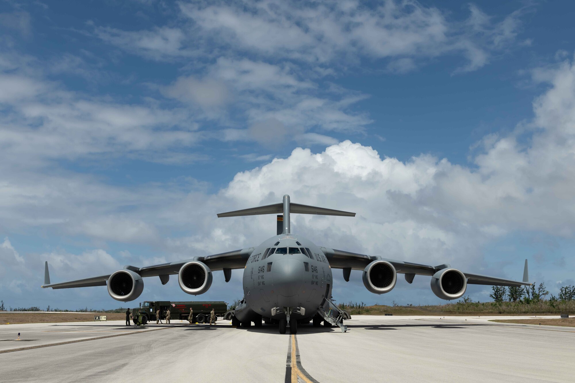 U.S. Air Force Airmen pump fuel from a C-17 Globemaster to a fuel truck at Tinian International Airport, Tinian, during exercise Resilient Typhoon, April 23, 2019. The aircraft dispersal exercise, based from Andersen Air Force Base, Guam, empowered Airmen at the tactical level to employ new approaches to operations in order to increase resiliency and readiness.  (U.S. Air Force photo by Airman 1st Class Matthew Seefeldt)