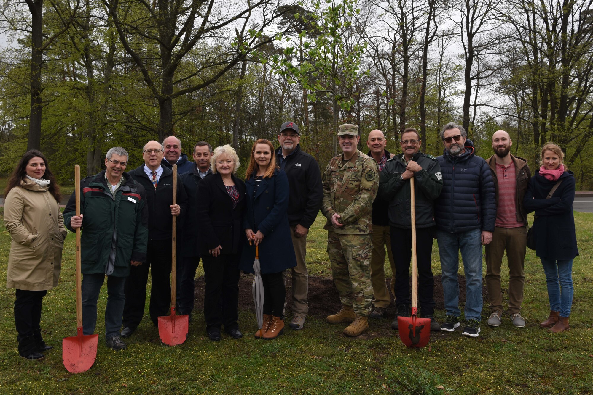 Brig. Gen. Mark R. August, 86th Airlift Wing commander, poses for a photo with members of the German forest authority, during an Earth Day tree planting ceremony on Ramstein Air Base, Germany, April, 26, 2019. Earth Day is an annual occurrence honored around the world to campaign and garnish support for environmental protection.