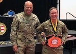 Army 1st Lt. Valerie Stearns, the executive officer with the Ohio Army National Guard’s 1191st Engineer Company, stands with Army Maj. Gen. John C. Harris Jr., then-Ohio National Guard assistant adjutant general for Army, after Stearns won the lightweight division championship at the 2018 Ohio Army National Guard Combatives Tournament held at the Maj. Gen. Robert Beightler Armory in Columbus, Ohio, Aug. 19, 2018. Stearns has found that combatives is another way she can engage her competitive spirit.