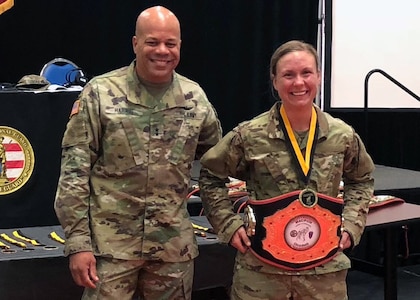 Army 1st Lt. Valerie Stearns, the executive officer with the Ohio Army National Guard’s 1191st Engineer Company, stands with Army Maj. Gen. John C. Harris Jr., then-Ohio National Guard assistant adjutant general for Army, after Stearns won the lightweight division championship at the 2018 Ohio Army National Guard Combatives Tournament held at the Maj. Gen. Robert Beightler Armory in Columbus, Ohio, Aug. 19, 2018. Stearns has found that combatives is another way she can engage her competitive spirit.