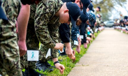 190405-N-ET513-0089 PORTSMOUTH, Va. (April 5, 2019) Sailors assigned to the aircraft carrier USS George H.W. Bush (CVN 77) plant flags with encouraging messages during a kickoff event for Sexual Assault Awareness and Prevention Month. The event was a combined effort with GWHB Sailors and Sailors from Norfolk Naval Shipyard. GHWB is at Norfolk Naval Shipyard (NNSY) undergoing a Docking Planned Incremental Availability (DPIA). (U.S. Navy Photo by Mass Communication Specialist 3rd Class Kallysta Castillo)