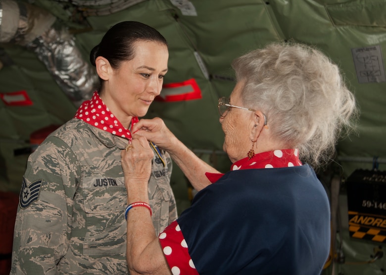 Mae Krier, an original “Rosie the Riveter” who helped build B-17s and B-52s during WWII, ties a bandana on Tech Sgt. Kat Justen, 459th Air Refueling Wing, non-commissioned officer in charge of Public Affairs, while on a tour at the 459th Air Refueling Wing at Joint Base Andrews, Md., April 30, 2019. Krier became a fan of Tech Sgt. Justen after seeing her popular art work hanging in the Air Force wing at the Pentagon. (U.S. Air Force photo by Staff Sgt. Cierra Presentado)