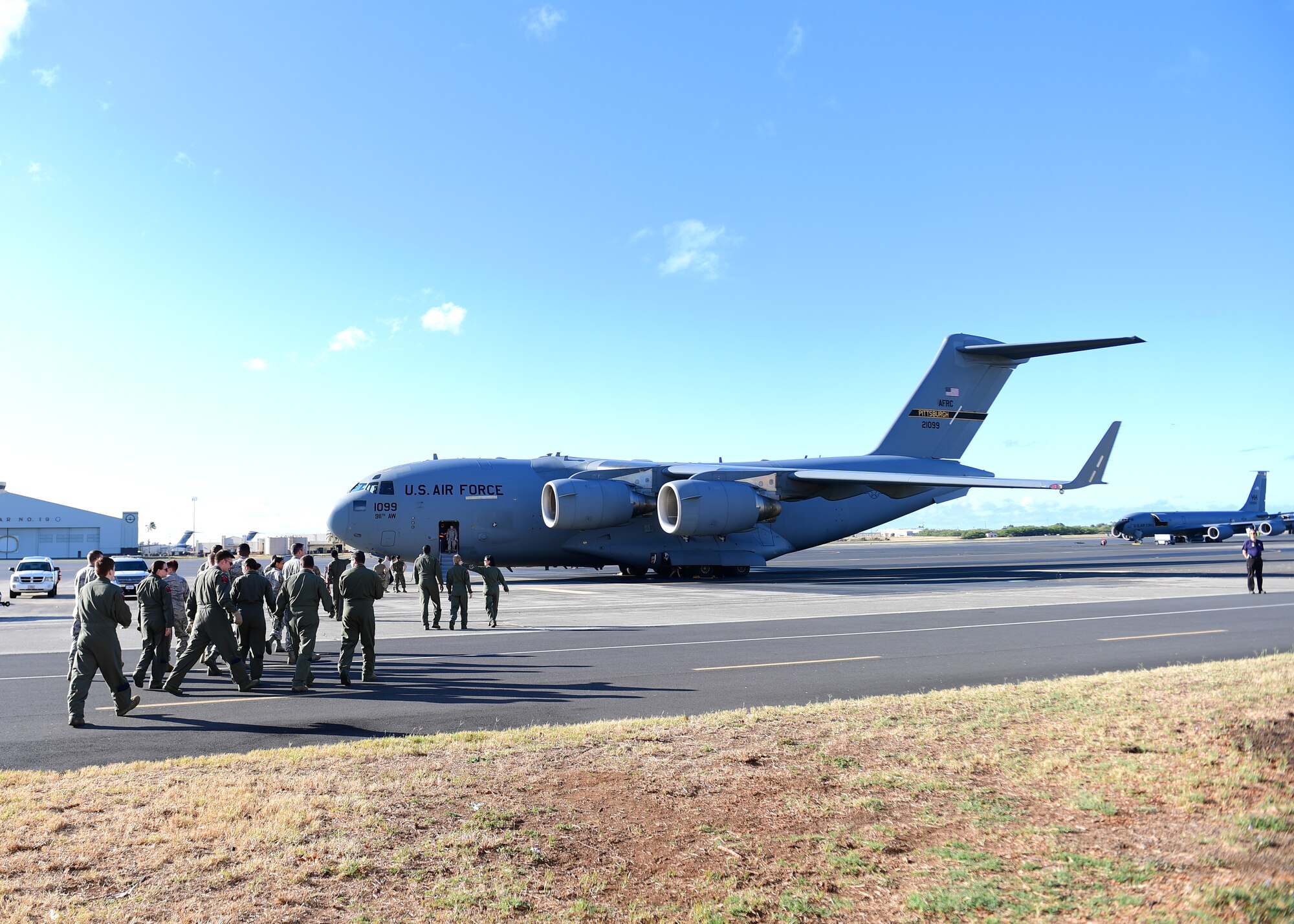 Airmen from the 911th Aeromedical Evacuation Squadron, 914th AES, and 18th Aeromedical Evacuation Detachment 1, based out of Joint Base Pearl Harbor-Hickam, Hawaii but attached to Kadena Air Base, Japan, walk out to a 911th Airlift Wing C-17 Globemaster III at Joint Base Pearl Harbor-Hickam, Hawaii April 25, 2019. The 911th AW C-17 had just come back from picking up patients at Kadena Air Force Base, Japan to bring back to the United States for continued treatment. (U.S. Air Force Photo by Senior Airman Grace Thomson)