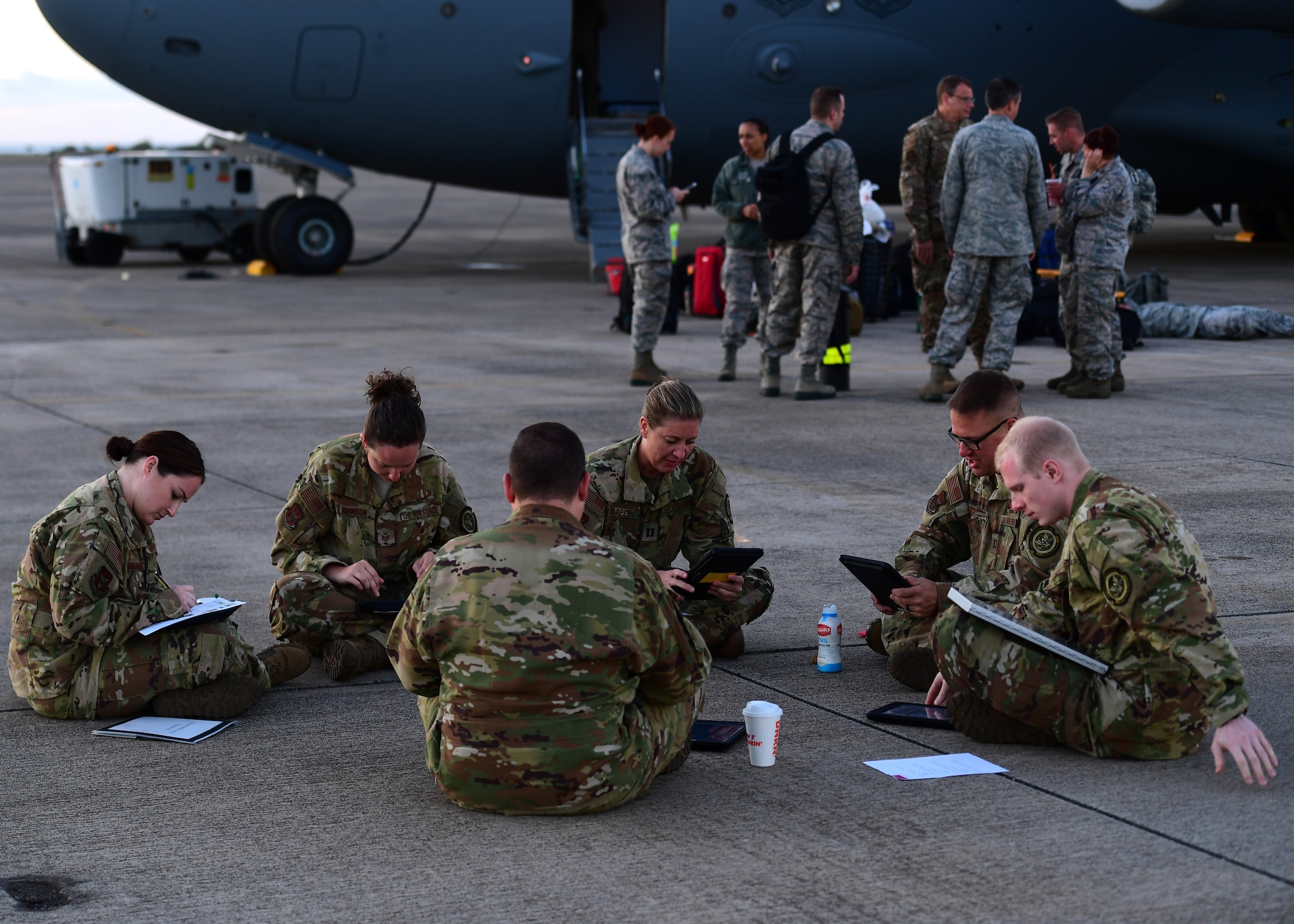 Airmen from the 911th Aeromedical Evacuation Squadron sit and study at Barbers Point Airfield, Hawaii April 26, 2019. During the flight home the 911th AES did training with their simulated patients as well as continued to go over in air medical procedures.(U.S. Air Force Photo by Senior Airman Grace Thomson)