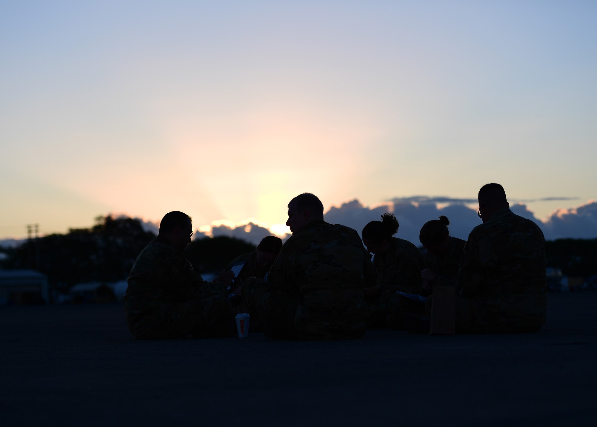 Airmen from the 911th Aeromedical Evacuation Squadron sit and study at Barbers Point Airfield, Hawaii April 26, 2019. The 911th AES trained throughout the week and went over ground procedures as well as in air medical procedures. (U.S. Air Force Photo by Senior Airman Grace Thomson)