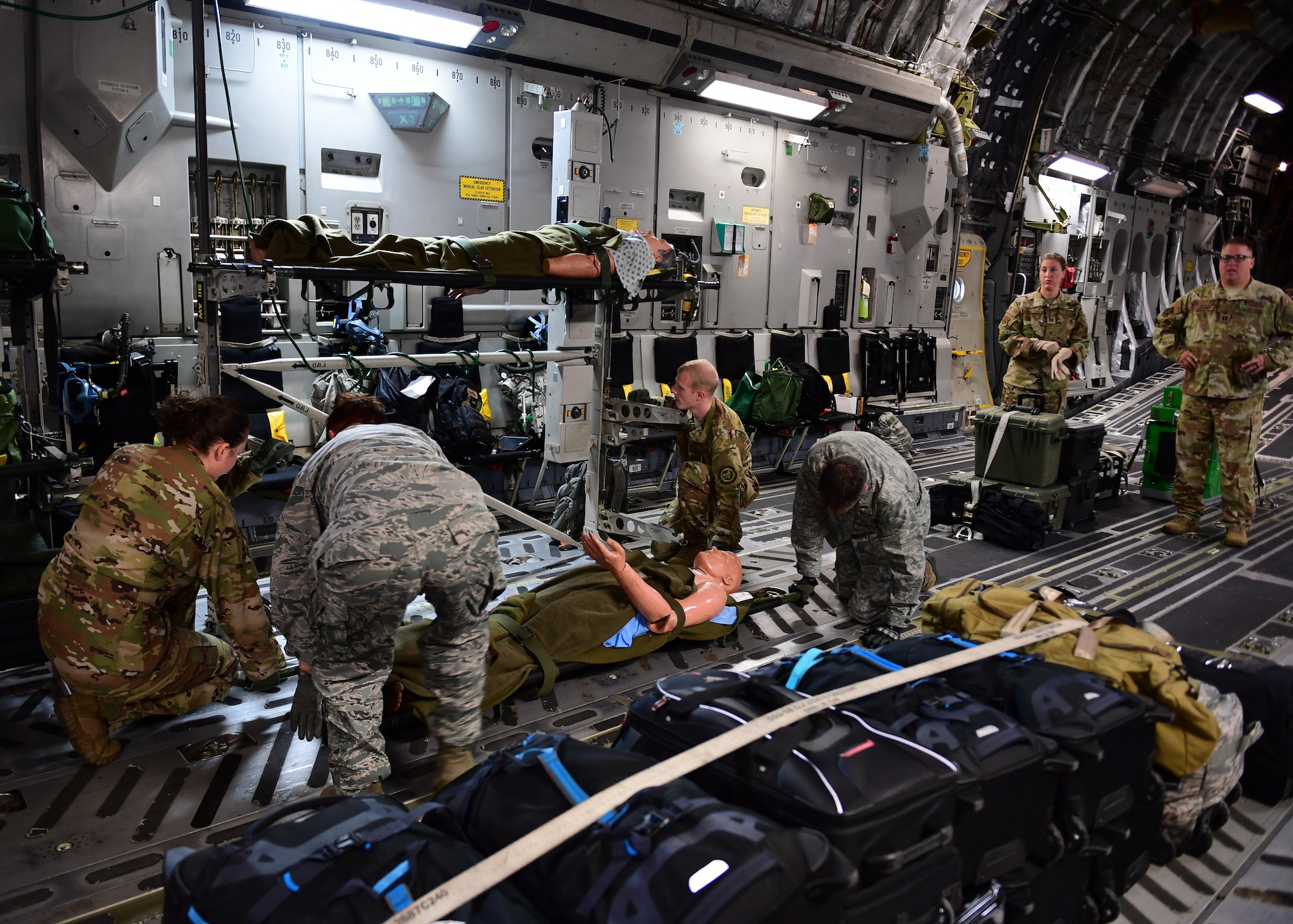 Airmen from the 911th Aeromedical Evacuation Squadron carry simulated patients at Barbers Point Airfield, Hawaii April 26, 2019. The 911th AES trained throughout the week and went over ground procedures as well as in air medical procedures. (U.S. Air Force Photo by Senior Airman Grace Thomson)