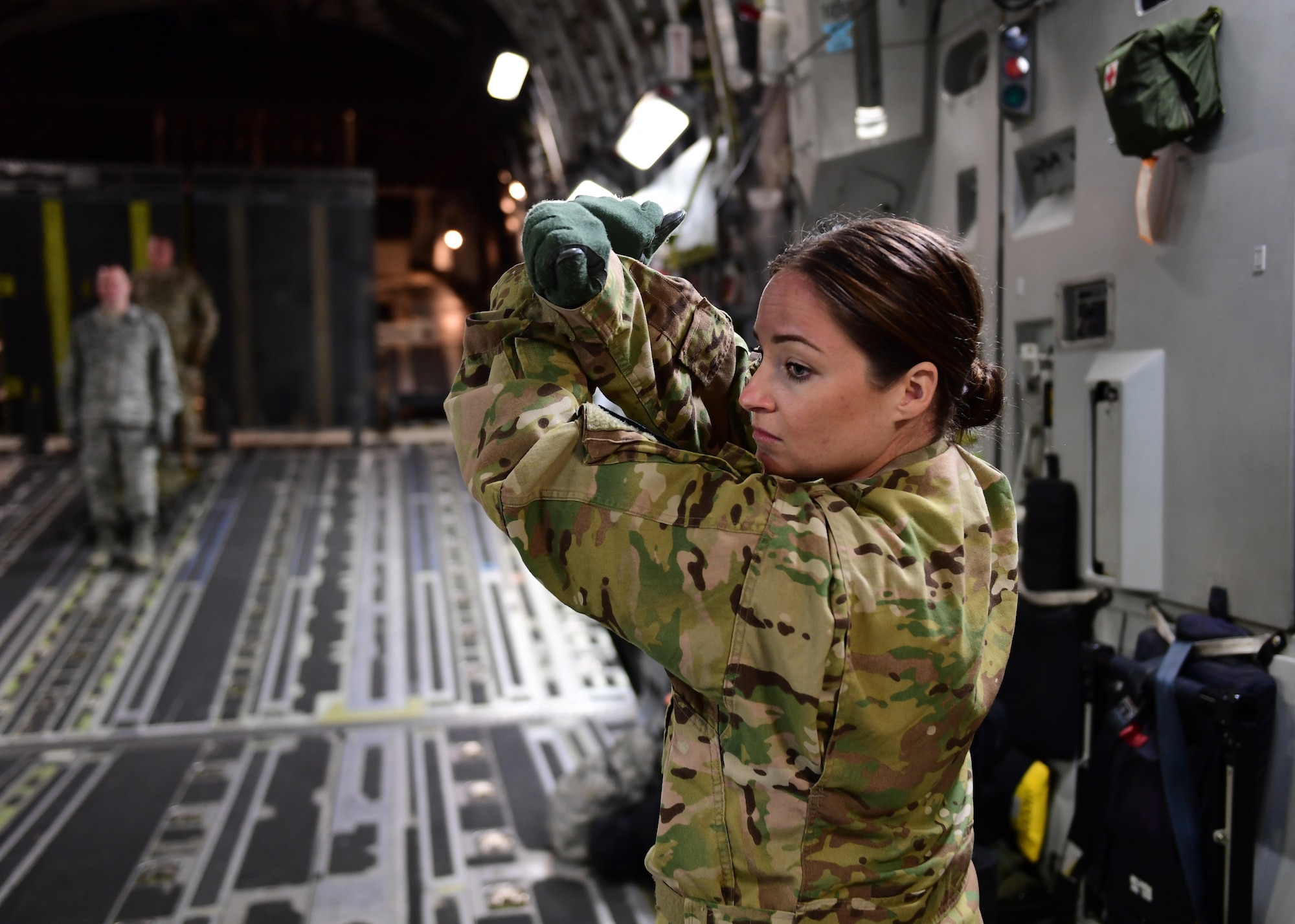 Capt. Holly Gongaware, 911th Aeromedical Evacuation Squadron flight nurse, directs Airmen with litters at Barbers Point Airfield, Hawaii April 26, 2019. The litter is a stretcher with a simulated patient on it that needs to be secured for flight.(U.S. Air Force Photo by Senior Airman Grace Thomson)