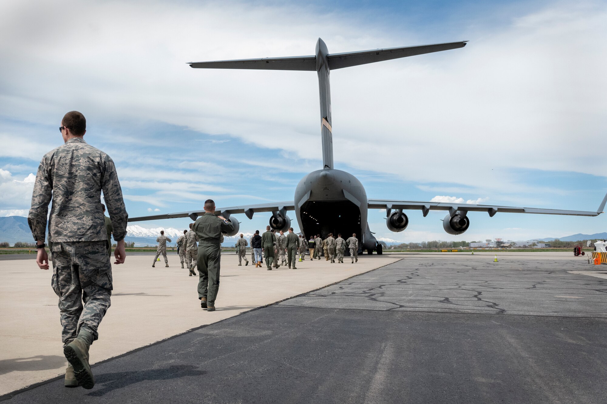 ROTC cadets walk towards a C-17 Globemaster III assigned to the 97th Air Mobility Wing, April 20, 2019, Provo, Utah. The cadets were given the opportunity to ride in a C-17 as a recruiting opportunity so they could understand more of what pilots do on a regular basis. (U.S. Air Force photo by Airman 1st Class Jeremy Wentworth)