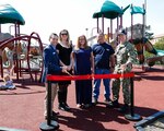 Norfolk Naval Shipyard's MWR Director Chad Rickner, CNIC Recreation Manager Leslie Gould, Contractor for Bliss Products Kelly Robinson, NNSY Facilities Development Foreman Steve O'Neal, and Norfolk Naval Shipyard Commander Capt. Kai Torkelson cut the ribbon in celebration of the new picnic tables and playground equipment at Scott Center Annex.