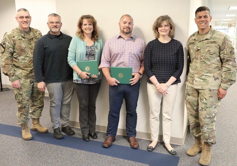 Middle East District Commander Col. Stephen Bales,  Supervisor Carlos Ramos, Contract Specialist Andrea Greene, Program Manager Pete DeMattei, Supervisor Annie Cain and Transatlantic Division Commander Col. Mark C. Quander, pose for a group photo following the presentation of Civilian Service Commendation Medals to Greene and DeMattei, during a ceremony held at the TAD headquarters in Winchester, Va., on April 25, 2019.