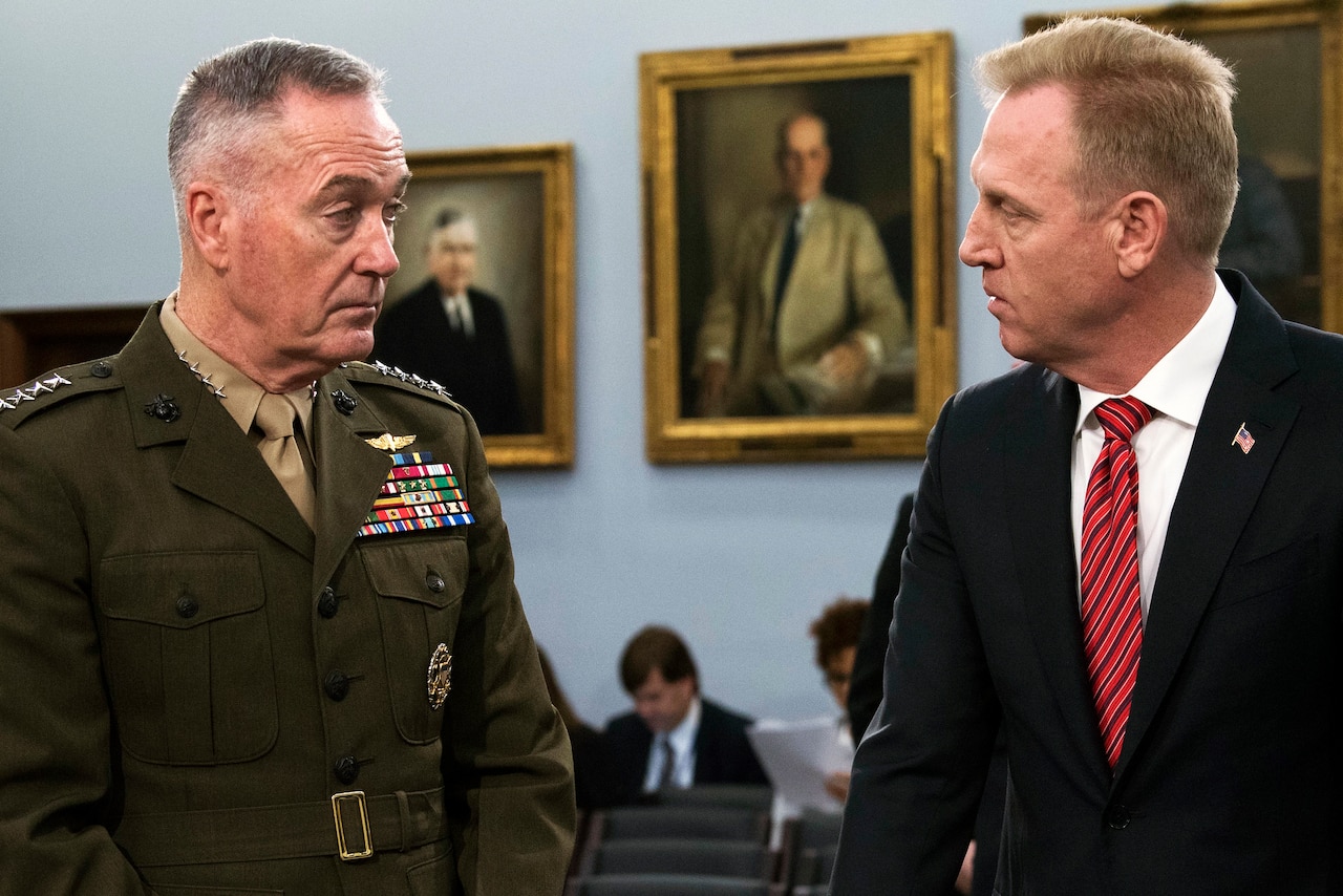 Two defense leaders speak together .