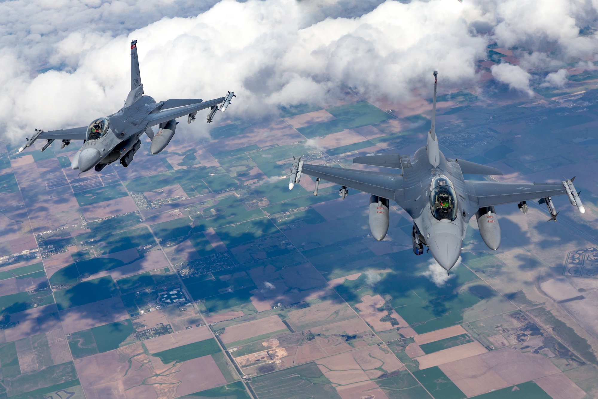 Two 138th Fighter Wing F-16 Fighting Falcons from Tulsa Air National Guard Base, Oklahoma, fly behind a KC-135R Stratotanker April 25, 2019. The Stratotanker, from the 507th Air Refueling Wing at Tinker Air Force Base, Oklahoma, refueled four 138th Fighter Wing F-16 Fighting Falcons during flight operations over Kansas. (Courtesy photo by Mike Killian)