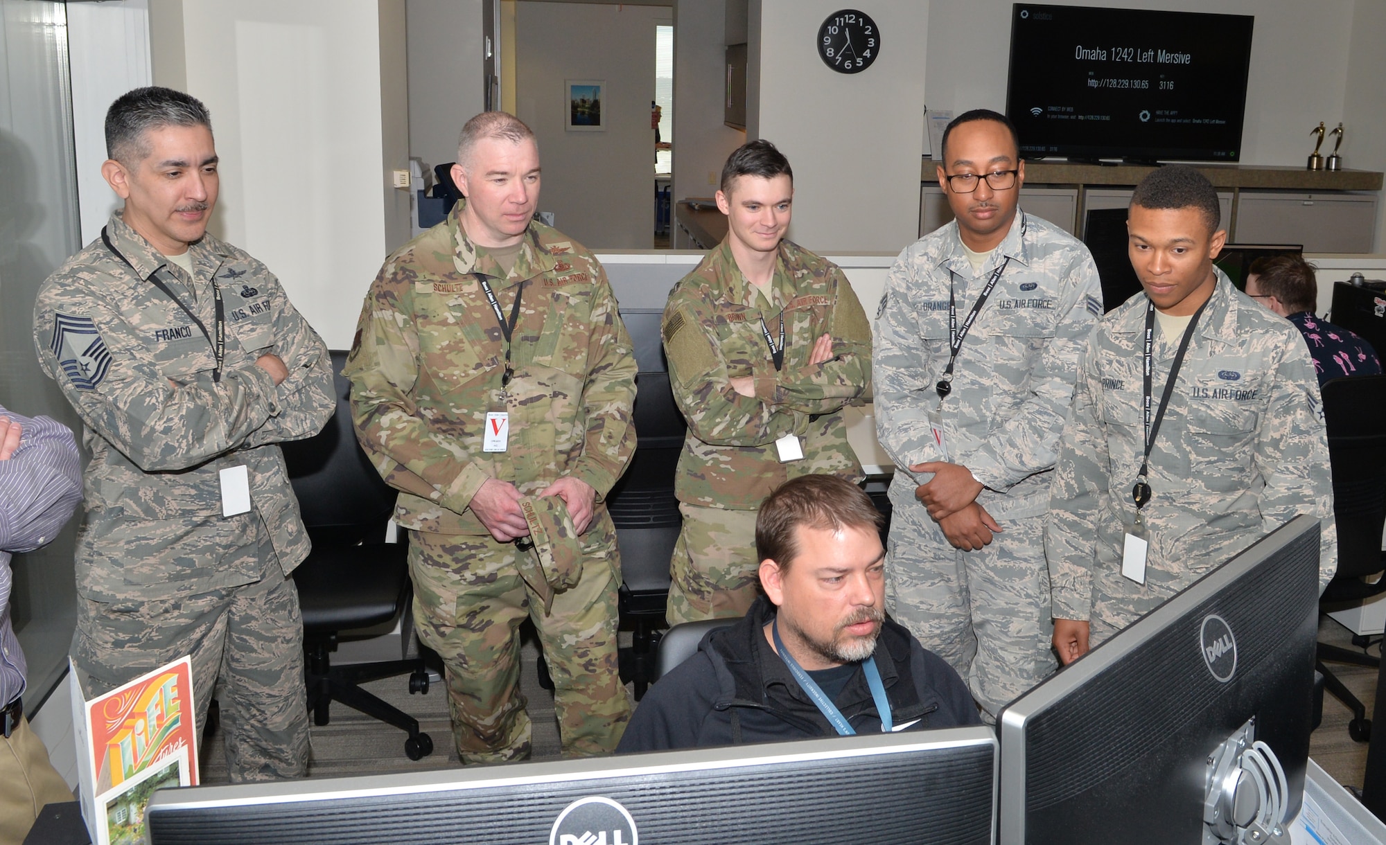 Representatives of the 55th Communications Group observe Jacob Roarke, Booz Allen Hamilton game technician, April 19, 2019, in downtown Omaha, Nebraska. He demonstrated some of the requirements necessary in developing portions of the virtual reality environment being designed specifically for members of the communications community. (U.S. Air Force photo by D.P. Heard)