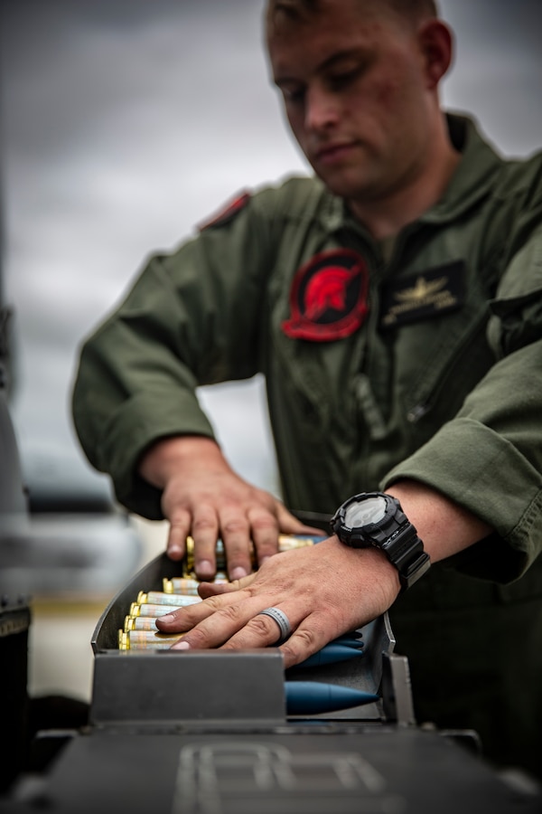 U.S. Marine Corps Cpl. Kyle Andreoli-Brown, an aircraft ordnance technician Marine Light Attack Helicopter Training Squadron 303, Marine Aircraft Group 39, 3rd Marine Aircraft Wing, loads ammunition onto an AH-1Z Viper helicopter during an aircraft ordnance load at Marine Corps Air Station Camp Pendleton, California, April 30, 2019. Ordnance loads are conducted regularly to support the required weapon qualifications and training of aircraft crew members and crew chiefs on the various ranges aboard Marine Corps Base Camp Pendleton. (U.S. Marine Corps photo by Cpl. Dylan Chagnon)