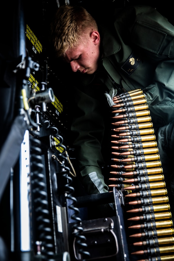 U.S. Marine Corps Cpl. Chase Kranz, an aviation logistics information management system specialist with Marine Light Attack Helicopter Training Squadron 303, Marine Aircraft Group 39, 3rd Marine Aircraft Wing, loads ammunition onto a UH-1Y Venom helicopter during an aircraft ordnance load at Marine Corps Air Station Camp Pendleton, California, April 30, 2019. Ordnance loads are conducted regularly to support the required weapon qualifications and training of aircraft crew members and crew chiefs on the various ranges aboard Marine Corps Base Camp Pendleton. (U.S. Marine Corps photo by Cpl. Dylan Chagnon)