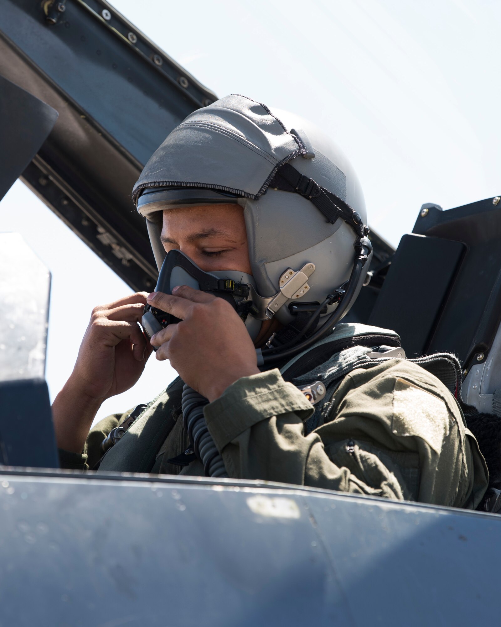Airman 1st Class Mequail Fridge, 311th Aircraft Maintenance Unit crew chief, dons his helmet before a familiarization flight, April 25, 2019, on Hill Air Force Base, Utah. The 311th Fighter Squadron had a goal of eight familiarization flights per day for operations and maintenance personnel during exercise Venom 19-01. (U.S. Air Force photo by Staff Sgt. BreeAnn Sachs)