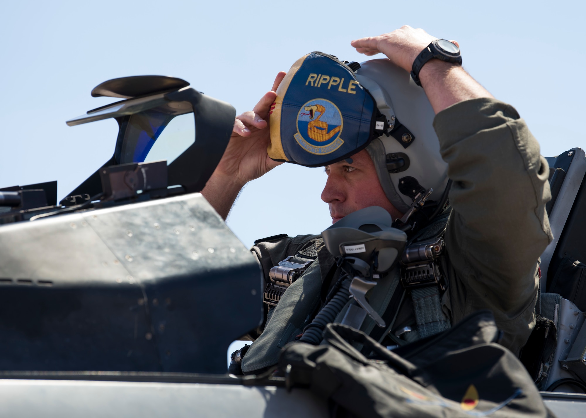Maj. Jon Farragher, 311th Fighter Squadron assistant director of operations, dons his helmet before flying a familiarization flight for Airman 1st Class Mequail Fridge, April 25, 2019, on Hill Air Force Base, Utah. The goal of a FAM flight is to educate ground personnel about their impact on the mission. (U.S. Air Force photo by Staff Sgt. BreeAnn Sachs)