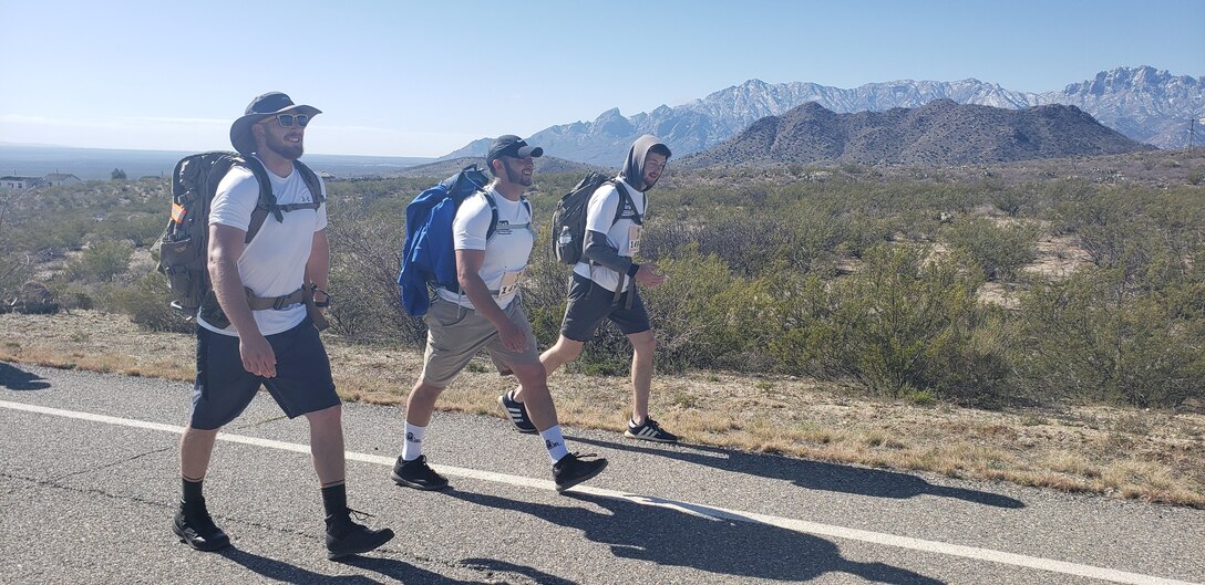 (l-r): Albuquerque District team members Kevin Vigil, Adam Baros, and Dakota Brodie participate in the 2019 Bataan Memorial Death March, March 17, 2019.