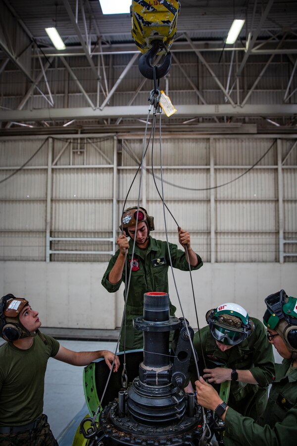 U.S. Marines with Marine Light Attack Helicopter Squadron 469, Marine Aircraft Group 39, 3rd Marine Aircraft Wing, lift the swash blade of a UH-1Y Venom helicopter during routine maintenance at Marine Corps Air Station (MCAS) Camp Pendleton, California, April 29, 2019. Routine aircraft maintenance is performed around-the-clock to ensure that the aircraft housed at MCAS Camp Pendleton are ready to perform daily flight operations. (U.S. Marine Corps photo by Cpl. Dylan Chagnon)