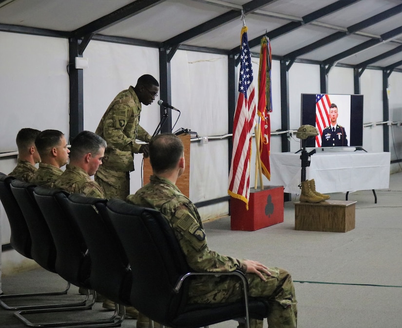 Spc. Chad Williams, 101st Airborne Division, speaks as a close friend of Spc. Ryan Riley during a memorial service at Qayyarah West Airfield, Iraq, March 25, 2019.