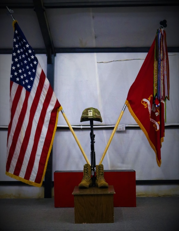 Identification tags for Spc. Ryan Riley hang from the Fallen Soldier Cross during a unit memorial service in Qayyarah West Airfield, Iraq, April 25, 2019. The Fallen Soldier Cross, also known as a Battle Cross, dates back to at least the American Civil War as a means of identifying the location of fallen Soldiers on the field. Today it is often a means of showing respect for the dead among the living members of the unit.