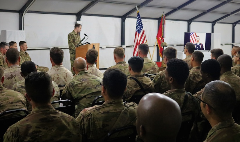 Capt. Daniel Hurd, a 101st Airborne Division chaplain, delivers reflections during a memorial service for Spc. Ryan Riley at Qayyarah West Airfield, Iraq, March 25, 2019.
