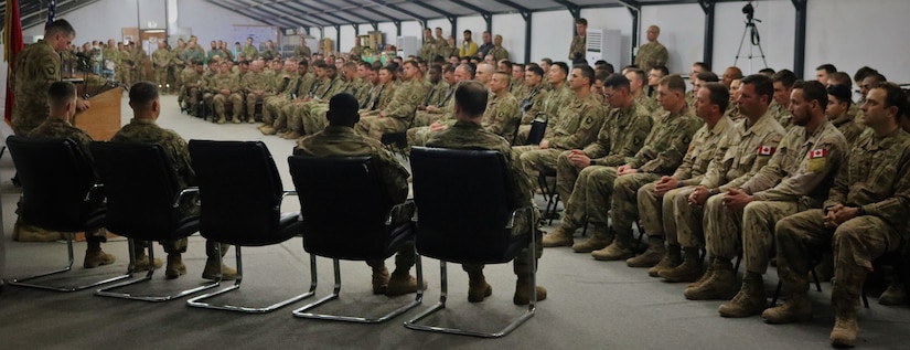 Cpl. Cody Roberts, 101st Airborne Division, speaks during a memorial service for Spc. Ryan Riley at Qayyarah West Airfield, Iraq, March 25, 2019. Roberts served as Riley's section chief.