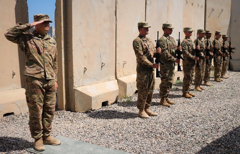 Sgt. Jeffery Love, 101st Airborne Division, leads the  firing of three rifle volleys in respect for Spc. Ryan Riley during a memorial service at Qayyarah West Airfield, Iraq, March 25, 2019.