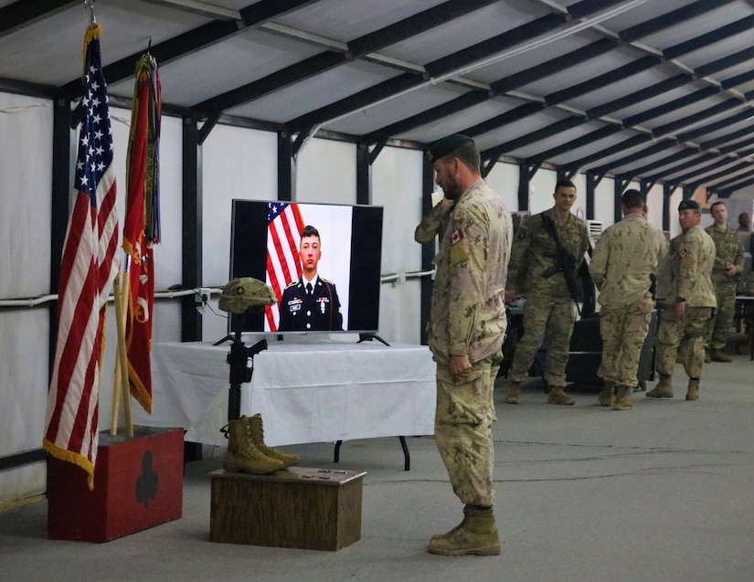 Soldiers of the 101st Airborne Division and other units render honors in respect following the memorial service for Spc. Ryan Dennis Orin Riley at Qayyarah West Airfield, Iraq, March 25, 2019.