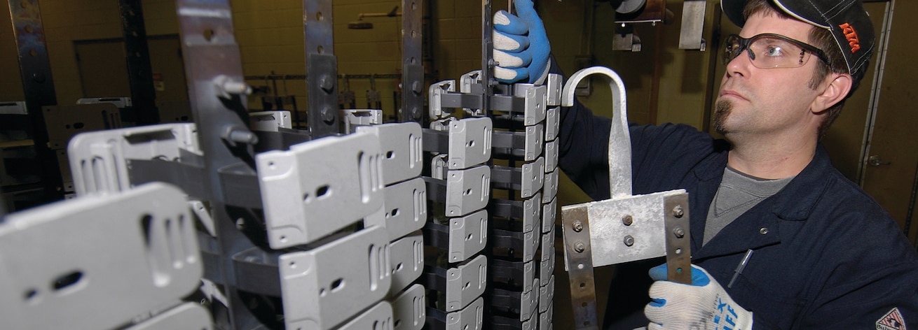 Photo of employee working on helmet bracket assemblies