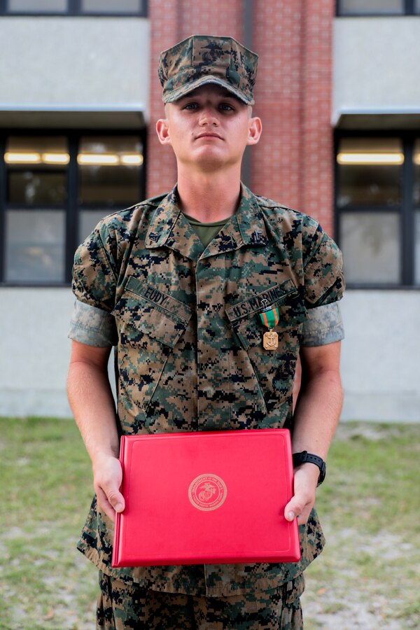 Lance Cpl. Caleb Eudy, with Charlie Company, 1st Recruit Training Battalion, is awarded a Navy and Marine Corps Achievement Medal on Parris Island, S.C. April 26, 2019. An Arab, AL native, Eudy was diagnosed with Lymphoma when he went through recruit training in 2016; after 956 days in recruit training  and on medical hold, he achieved his dream of becoming a Marine. (U.S. Marine Corps photo by Cpl. Andrew Neumann/Released)
