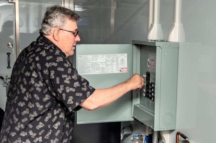 Rick Heinly, Logistics Management Specialist at Naval Surface Warfare Center, Port Hueneme Division, supplies power to the newly established Mobile Command center at Port Hueneme. The center is part of the command’s efforts to provide Navy ships with mobile repair capability.