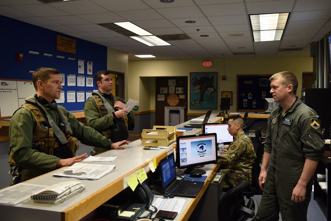 U.S. Air Force Maj. James Broncheau, 35th Fighter Squadron instructor pilot (right), preps Col. Jon Wheeler Jr., 8th Fighter Wing vice commander, and 1st Lt. Thomas Gray, 35th FS pilot, prior to flight at Kunsan Air Base, Republic of Korea, April 24, 2019. Wheeler and Gray were preparing for localized flight training. (U.S. Air Force photo by Staff Sgt. Joshua Edwards)