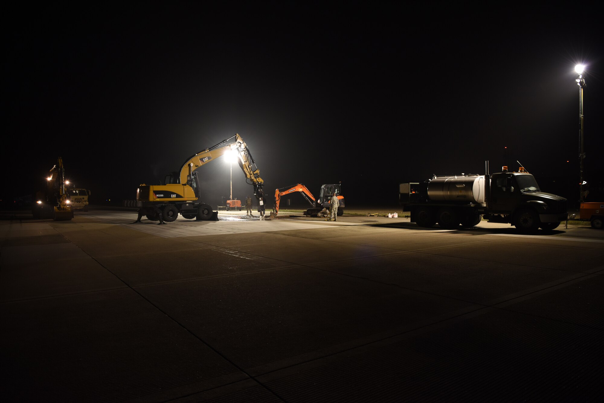 U.S. Air Force 8th Civil Engineer Squadron members work to repair a rupture at Kunsan Air Base, Republic of Korea, May 1, 2019. 8th CES and 8th Logistics Readiness Squadron members responded to incident and made the flight line operational again within 24 hours. (U.S. Air Force photo by Staff Sgt. Joshua Edwards)