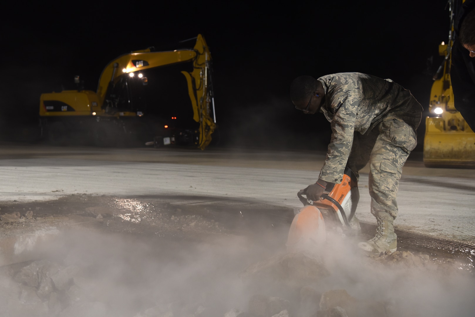 U.S. Air Force Airman 1st Class Curtis Carroll III, 8th Civil Engineer Squadron dirt boy, saws through cement at Kunsan Air Base, Republic of Korea, May 1, 2019. Carroll and other 8th CES members applied rapid airfield damage repair to quickly fix a rupture that damaged the flight line. (U.S. Air Force photo by Staff Sgt. Joshua Edwards)