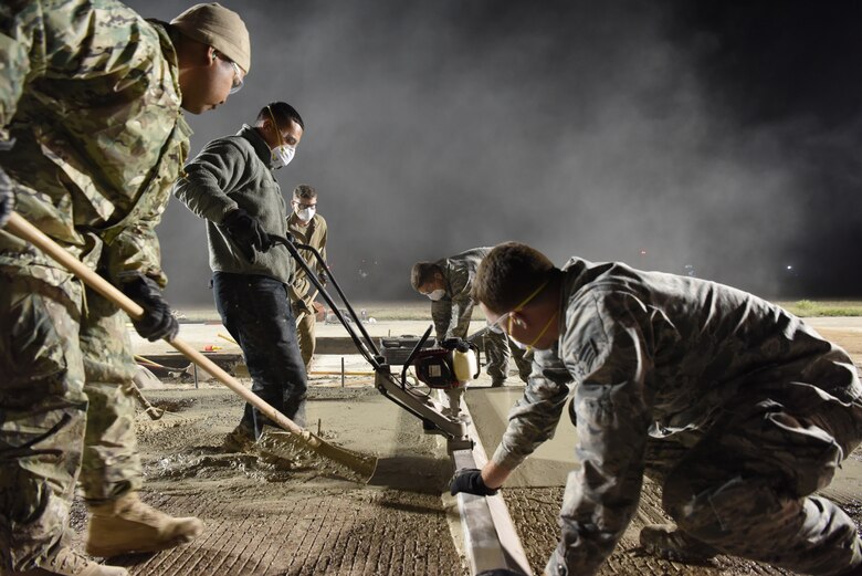 U.S. Air Force 8th Civil Engineer Squadron members smooth concrete on the flight line at Kunsan Air Base, Republic of Korea, May 2, 2019. The 8th CES applied rapid airfield damage repair methods to fix a rupture that caused damage to the flight line. (U.S. Air Force photo by Staff Sgt. Joshua Edwards)