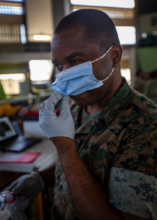U.S. Navy Petty Officer 3rd Class Gabriel Adjetey, a hospital corpsman with 4th Dental Battalion, 4th Marine Logistics Group, Marine Forces Reserve, puts on a face mask at Yauco, Puerto Rico, April 30, 2019, during Innovative Readiness Training Puerto Rico. The purpose of the IRT Puerto Rico is to provide dental, optometry and medical care to the community while performing joint military humanitarian operations. MARFORRES is participating in IRT Puerto Rico 2019 in order to maintain military readiness while strengthening alliances with partners. (U.S. Marine Corps photo by Sgt. Andy O. Martinez)