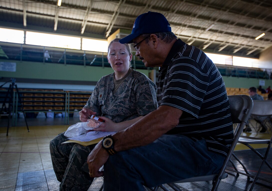 A U.S. Air Force Airman speaks with a patient about his prescription at Yauco, Puerto Rico, April 30, 2019, during Innovative Readiness Training Puerto Rico. The purpose of the IRT Puerto Rico is to provide dental, optometry and medical care to the community while performing joint military humanitarian operations. Marine Forces Reserve is participating in IRT Puerto Rico 2019 in order to maintain military readiness while strengthening alliances with partners. (U.S. Marine Corps photo by Sgt. Andy O. Martinez)