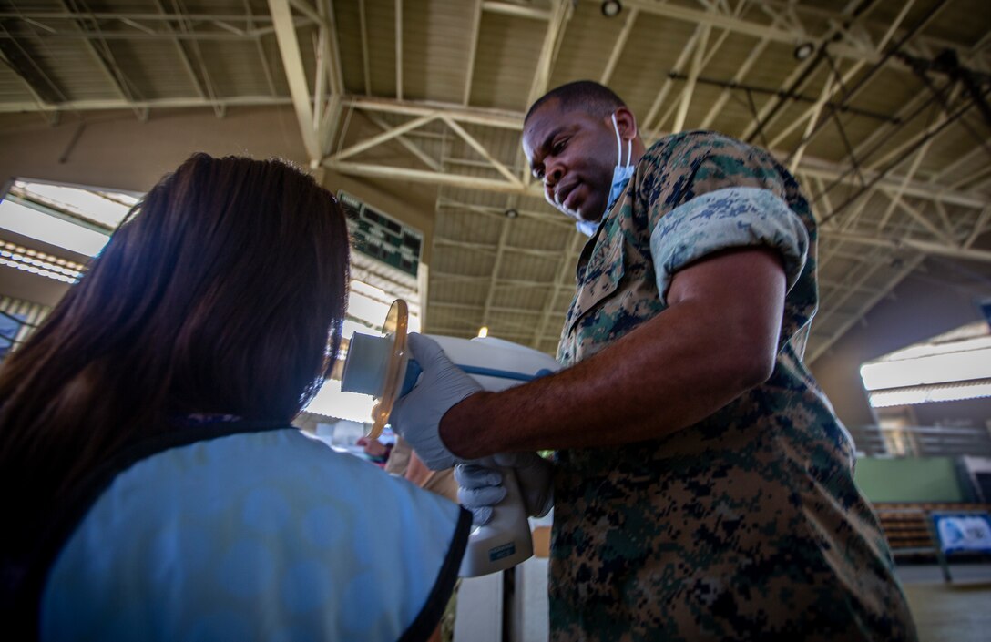 U.S. Navy Petty Officer 3rd Class Gabriel Adjetey, a hospital corpsman with 4th Dental Battalion, 4th Marine Logistics Group, Marine Forces Reserve, uses a handheld X-ray system on a patient at Yauco, Puerto Rico, April 30, 2019, during Innovative Readiness Training Puerto Rico. The purpose of the IRT Puerto Rico is to provide dental, optometry and medical care to the community while performing joint military humanitarian operations. MARFORRES is participating in IRT Puerto Rico 2019 in order to maintain military readiness while strengthening alliances with partners. (U.S. Marine Corps photo by Sgt. Andy O. Martinez)