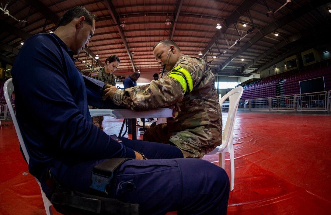 A Soldier checks a patient’s blood pressure at Ponce, Puerto Rico, April 27, 2019, during Innovative Readiness Training Puerto Rico. The purpose of the Innovative Readiness Training Puerto Rico is to provide dental, optometry and medical care to the community while performing joint military humanitarian operations. Marine Forces Reserve is participating in IRT Puerto Rico 2019 in order to maintain military readiness while strengthening alliances with partners. (U.S. Marine Corps photo by Sgt. Andy O. Martinez)