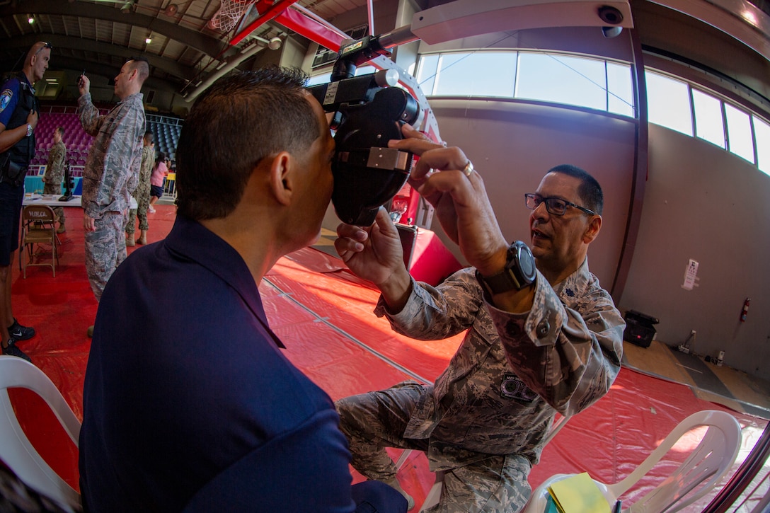 An Airman uses an illuminated phoropter refracting instrument to check a patient’s vision at Ponce, Puerto Rico, April 27, 2019, during Innovative Readiness Training Puerto Rico. The purpose of the Innovative Readiness Training Puerto Rico is to provide dental, optometry and medical care to the community while performing joint military humanitarian operations. Marine Forces Reserve is participating in IRT Puerto Rico 2019 in order to maintain military readiness while strengthening alliances with partners. (U.S. Marine Corps photo by Sgt. Andy O. Martinez)