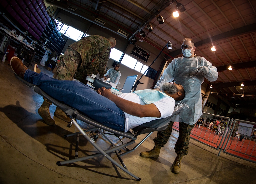 Navy Cmdr. Michael Cabassa, a general dentist with 4th Dental Battalion, 4th Marine Logistics Group, Marine Forces Reserve, prepares to treat a patient at Ponce, Puerto Rico, April 27, 2019, during Innovative Readiness Training Puerto Rico. The purpose of the Innovative Readiness Training Puerto Rico is to provide dental, optometry and medical care to the community while performing joint military humanitarian operations. Marine Forces Reserve is participating in IRT Puerto Rico 2019 in order to maintain military readiness while strengthening alliances with partners. (U.S. Marine Corps photo by Sgt. Andy O. Martinez)