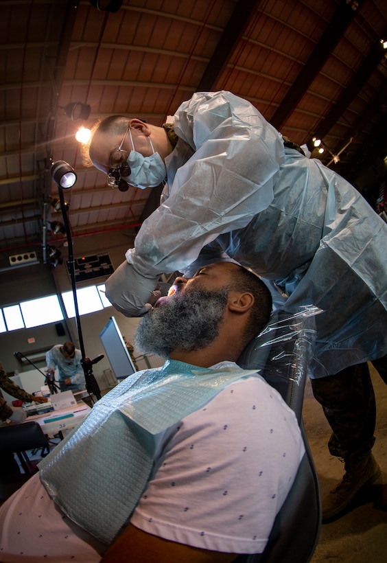 Navy Cmdr. Michael Cabassa, a general dentist with 4th Dental Battalion, 4th Marine Logistics Group, Marine Forces Reserve, reviews a patient’s teeth at Ponce, Puerto Rico, April 27, 2019, during Innovative Readiness Training Puerto Rico. The purpose of the Innovative Readiness Training Puerto Rico is to provide dental, optometry and medical care to the community while performing joint military humanitarian operations. Marine Forces Reserve is participating in IRT Puerto Rico 2019 in order to maintain military readiness while strengthening alliances with partners. (U.S. Marine Corps photo by Sgt. Andy O. Martinez)