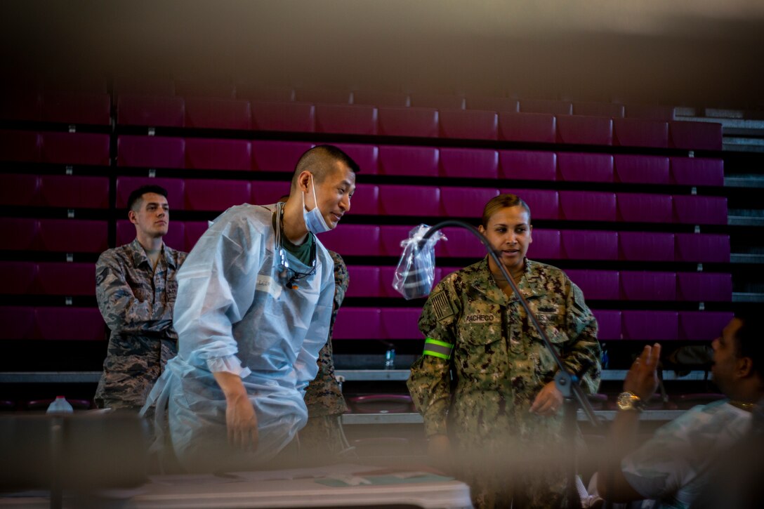 Navy Lt. Cmdr. Dean Chang, a dentist with 4th Dental Battalion, 4th Marine Logistics Group, Marine Forces Reserve, speaks with a patient at Ponce, Puerto Rico, April 27, 2019, during Innovative Readiness Training Puerto Rico. The purpose of the Innovative Readiness Training Puerto Rico is to provide dental, optometry and medical care to the community while performing joint military humanitarian operations. Marine Forces Reserve is participating in IRT Puerto Rico 2019 in order to maintain military readiness while strengthening alliances with partners. (U.S. Marine Corps photo by Sgt. Andy O. Martinez)