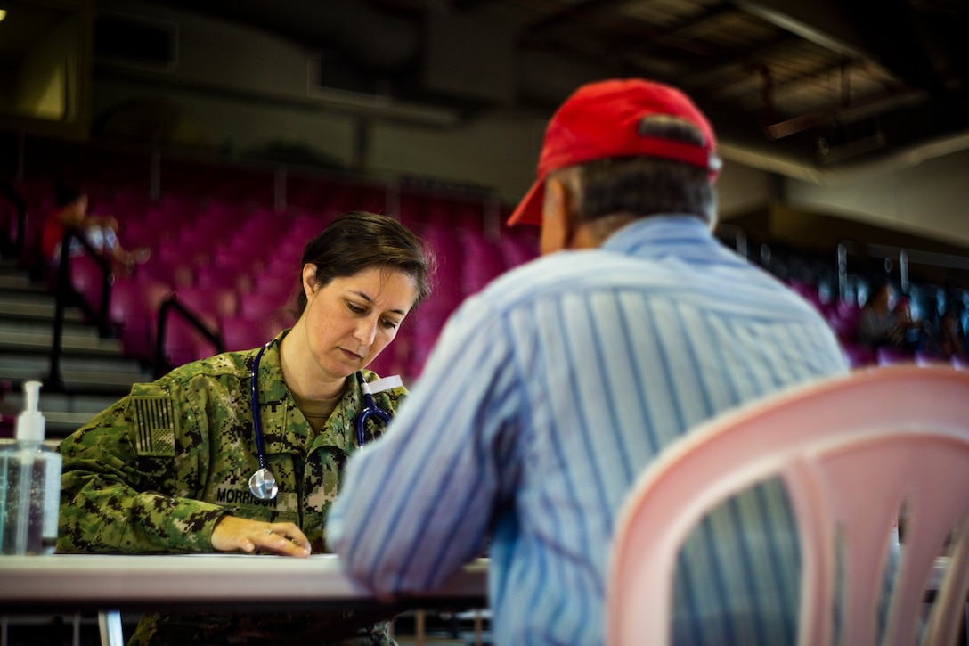 Navy Lt. Cmdr. Elisa Morrison, a nurse practitioner with Operational Health Support Unit Jacksonville, provides medical services to a patient at Ponce, Puerto Rico, April 27, 2019, during Innovative Readiness Training Puerto Rico. The purpose of the Innovative Readiness Training Puerto Rico is to provide dental, optometry and medical care to the community while performing joint military humanitarian operations. Marine Forces Reserve is participating in IRT Puerto Rico 2019 in order to maintain military readiness while strengthening alliances with partners. (U.S. Marine Corps photo by Sgt. Andy O. Martinez)