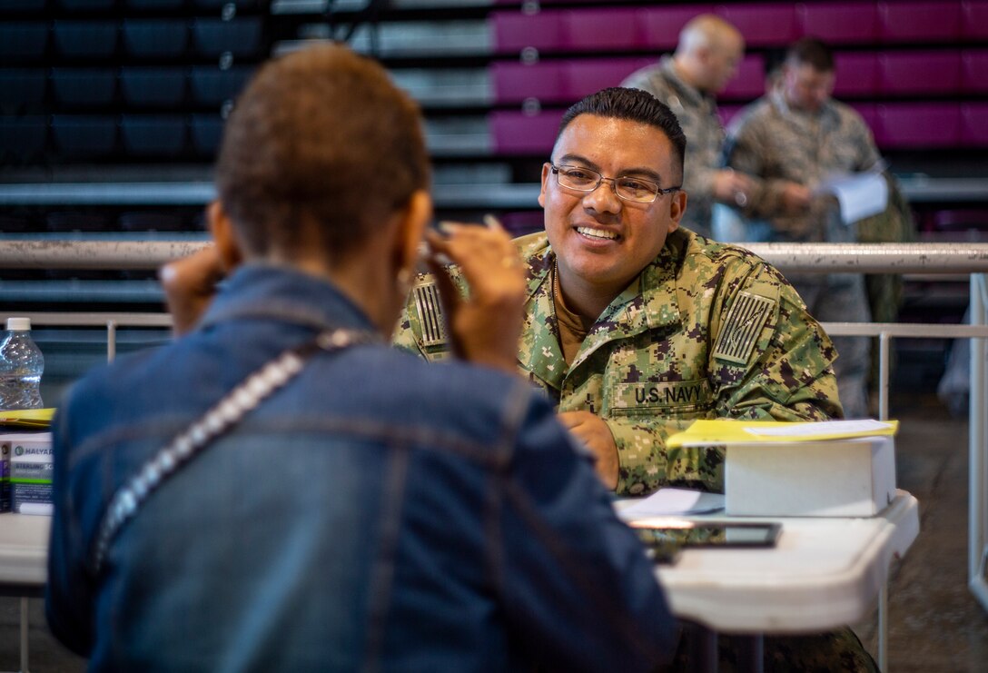 Navy Petty Officer 3rd Class Richard Marquez, a hospital corpsman with Expeditionary Medical Facility Camp Pendleton, helps a patient choose a pair of glasses at Ponce, Puerto Rico, April 27, 2019, during Innovative Readiness Training Puerto Rico. The purpose of the Innovative Readiness Training Puerto Rico is to provide dental, optometry and medical care to the community while performing joint military humanitarian operations. Marine Forces Reserve is participating in IRT Puerto Rico 2019 in order to maintain military readiness while strengthening alliances with partners. (U.S. Marine Corps photo by Sgt. Andy O. Martinez)