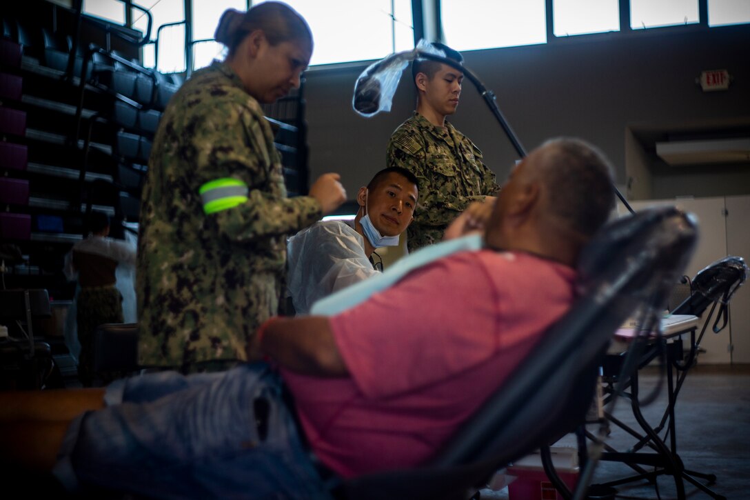 Navy Lt. Cmdr. Dean Chang, a dentist with 4th Dental Battalion, 4th Marine Logistics Group, Marine Forces Reserve, speaks with a patient at Ponce, Puerto Rico, April 27, 2019, during Innovative Readiness Training Puerto Rico. The purpose of the Innovative Readiness Training Puerto Rico is to provide dental, optometry and medical care to the community while performing joint military humanitarian operations. Marine Forces Reserve is participating in IRT Puerto Rico 2019 in order to maintain military readiness while strengthening alliances with partners. (U.S. Marine Corps photo by Sgt. Andy O. Martinez)