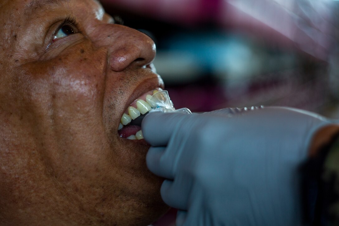 A patient receives dental care at Ponce, Puerto Rico, April 27, 2019, during Innovative Readiness Training Puerto Rico. The purpose of the Innovative Readiness Training Puerto Rico is to provide dental, optometry and medical care to the community while performing joint military humanitarian operations. Marine Forces Reserve is participating in IRT Puerto Rico 2019 in order to maintain military readiness while strengthening alliances with partners. (U.S. Marine Corps photo by Sgt. Andy O. Martinez)