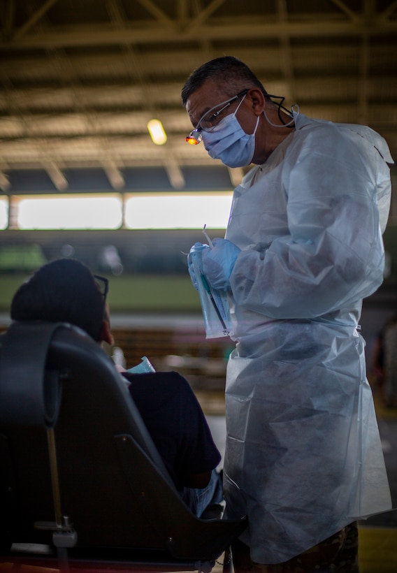 A U.S. Army Solider provides dental care to a patient at Yauco, Puerto Rico, April 28, 2019, during Innovative Readiness Training Puerto Rico. IRT Puerto Rico is also called Ola de Esperanza Sanadora, which translates to Healing Wave of Hope. This IRT is part of a civil and joint military program to improve military readiness while simultaneously providing quality services to underserved communities throughout the United States. (U.S. Marine Corps photo by Sgt. Andy O. Martinez)